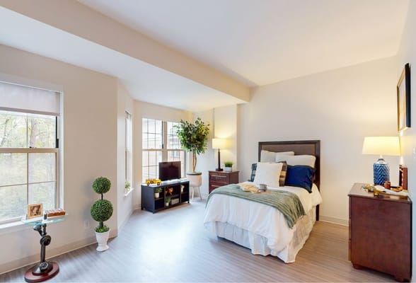 A cozy resident room with a bed and personal items