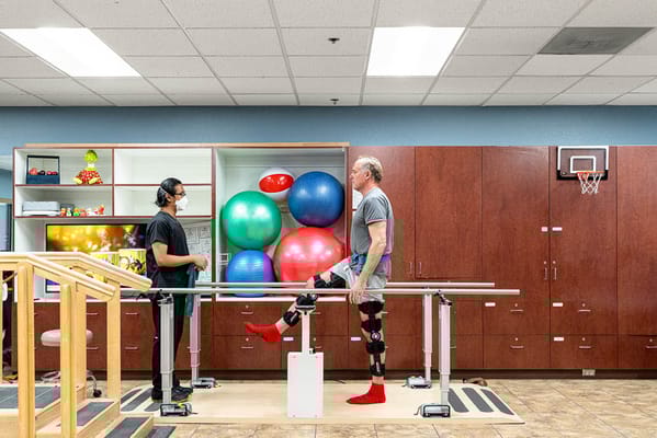 Therapist assisting a resident in a rehabilitation session