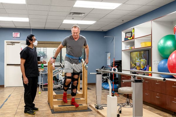 Therapist guiding resident during physical therapy session
