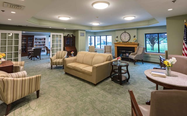 Bright and welcoming common area with seating and bookshelves