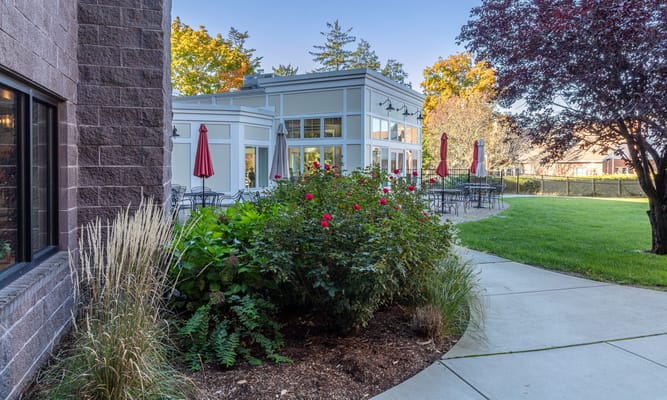 Pathway leading to outdoor seating area with gardens