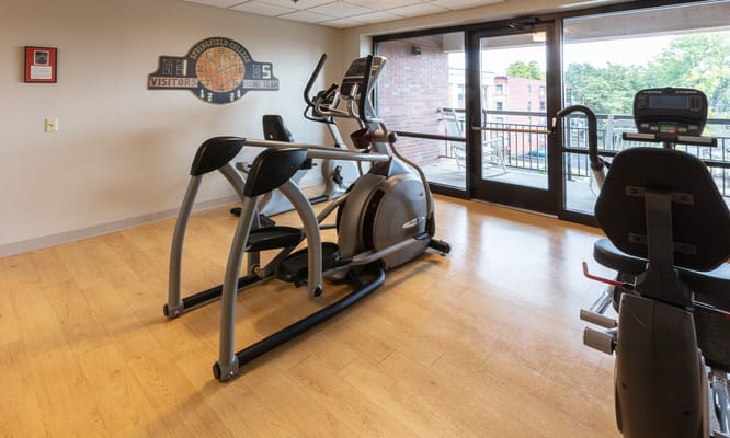 An interior fitness room with gym equipment