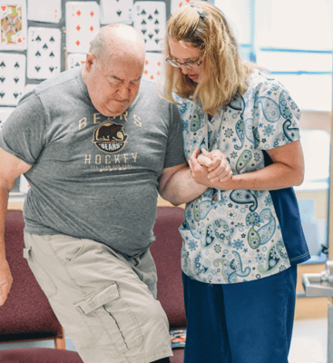 Staff assisting a resident during a therapeutic activity