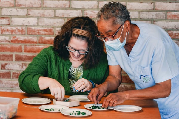 Residents engaging in a crafting activity with staff