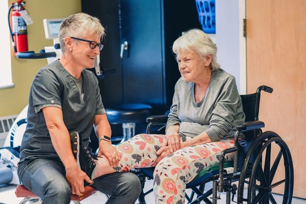 Staff assisting a resident in a therapy session