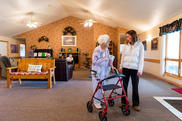 A staff member assisting a resident in a common area