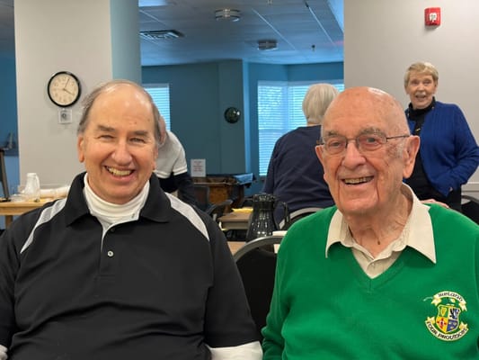 Two residents smiling in a common area