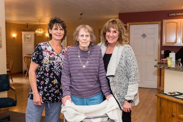 Staff members with a resident in a common area