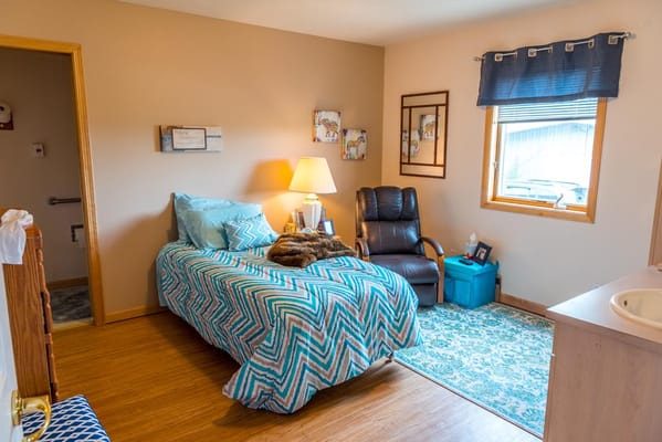 Private resident room with a bed and seating area