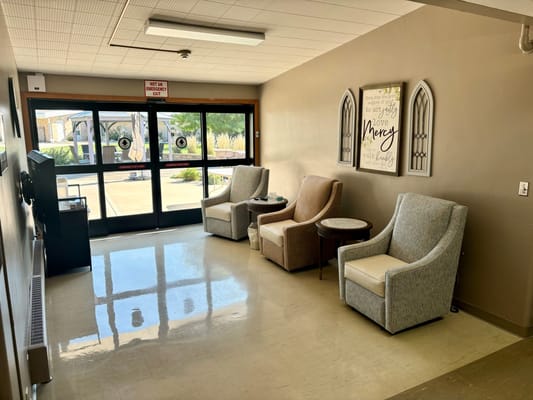 Bright interior lounge area with chairs and artwork
