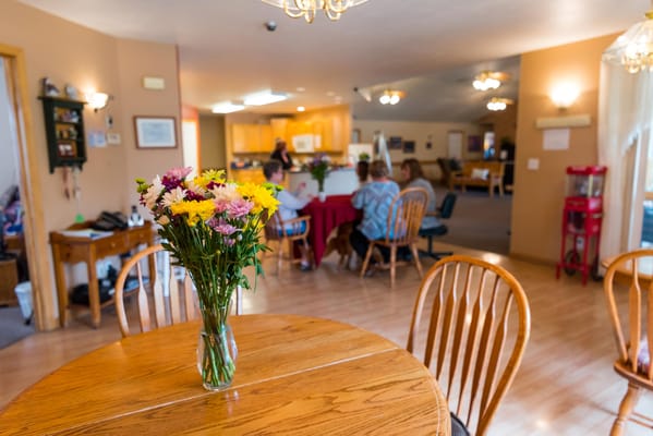 Interior common area with residents and flowers on table