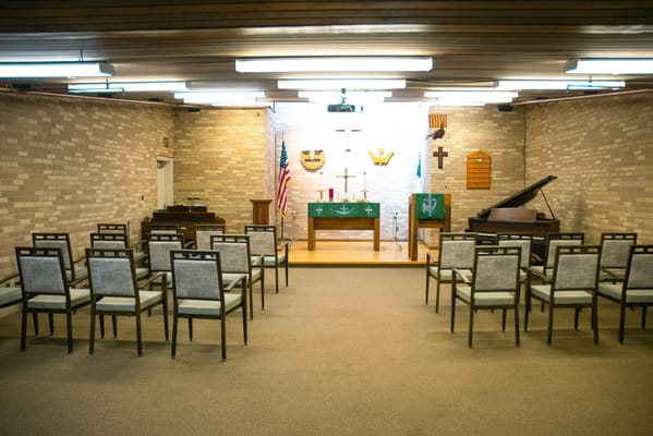 Interior view of a multi-purpose room with chairs and musical instruments