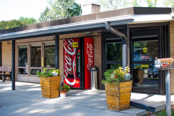 Exterior view of a facility entrance with a vending machine