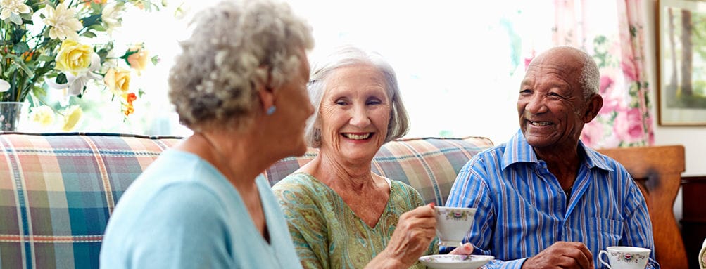 Seniors enjoying tea together in a cozy setting