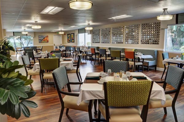 Bright dining room with tables set for meals