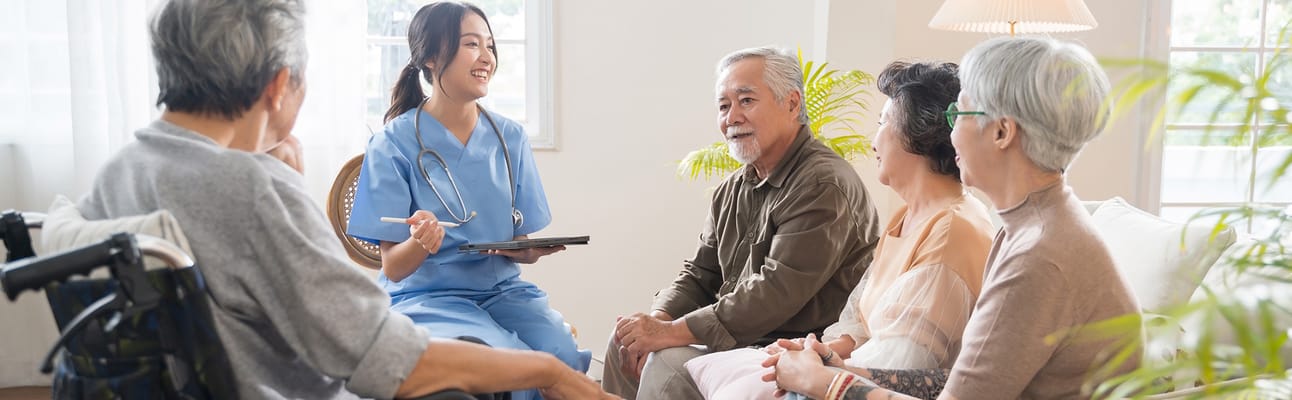 Staff member interacting with residents in a cozy setting