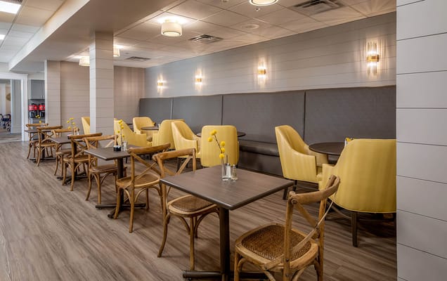 Bright dining area with yellow chairs and tables