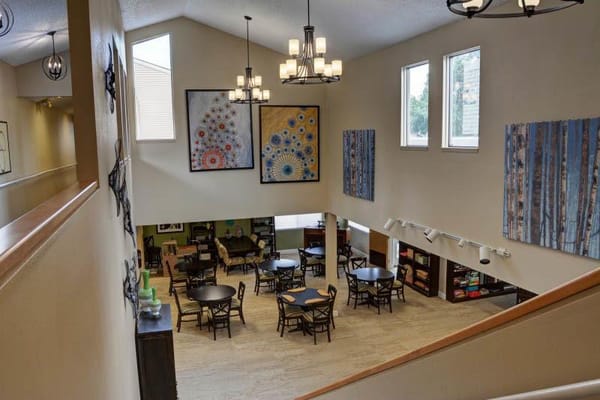 Common area with tables and artwork on the wall