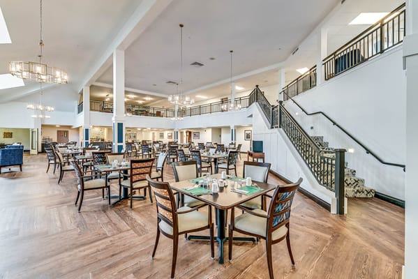 Spacious dining room with tables and chairs arranged