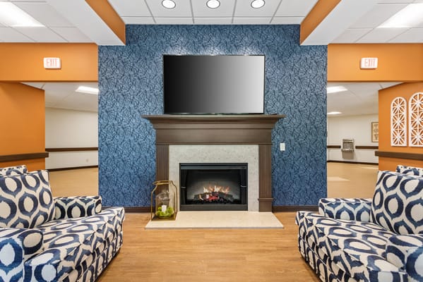 Bright common area with fireplace and seating