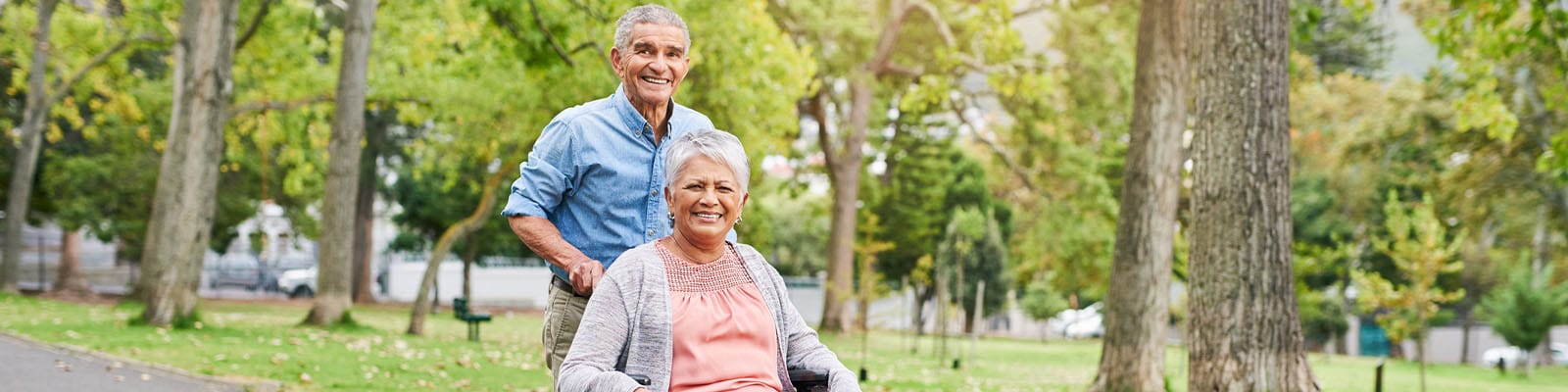 Two seniors enjoying a walk in a park