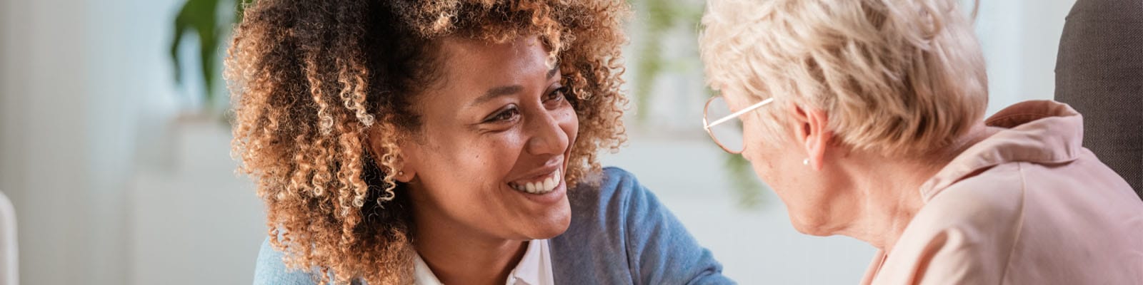 Caregiver interacting with a senior resident in a room