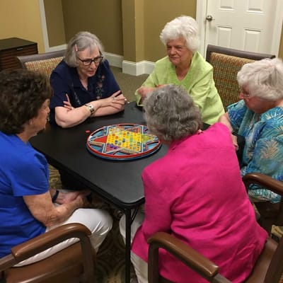 Residents enjoying a game around a table