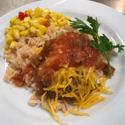 Plate of rice, corn, and cheesy casserole