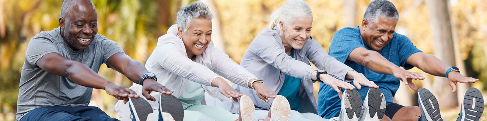 Group of seniors stretching outdoors in a fitness class