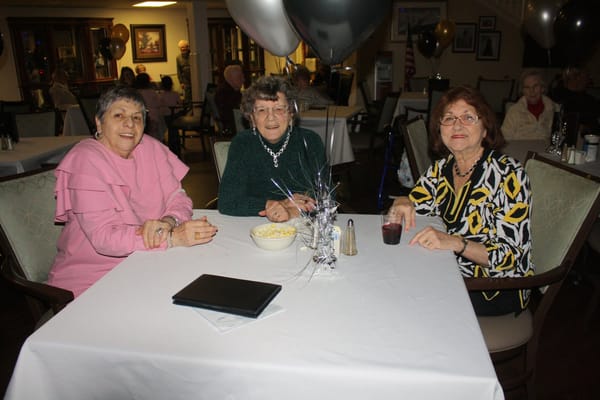 Three residents enjoying a social event at the facility