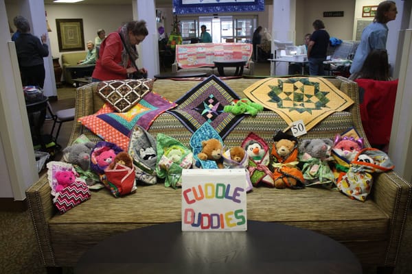 Residents showcasing their handmade 'Cuddle Buddies'