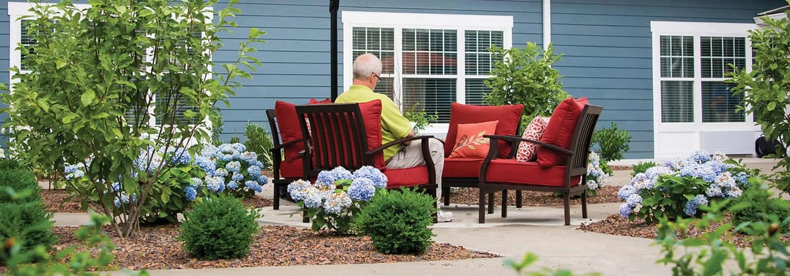 Resident enjoying a peaceful outdoor garden area