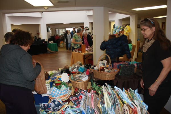 Residents shopping at a community event inside the facility
