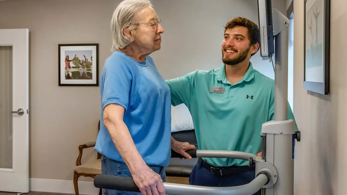 A staff member assisting a resident with therapy