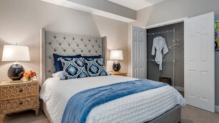 Cosy bedroom with a neatly made bed and wardrobe