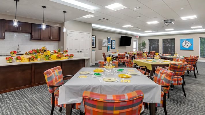 Bright dining room set for a meal with floral centerpieces