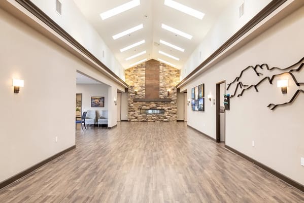 Spacious interior lobby with natural light and stone fireplace