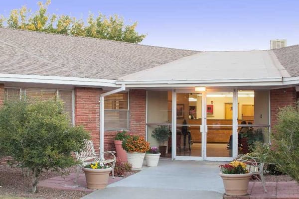 Front entrance of a senior living facility with flowers