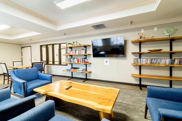 Common area with blue chairs and wooden table