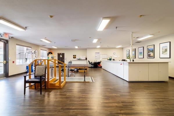 Bright interior of a facility's common area with seating and equipment