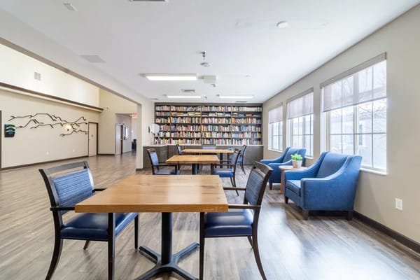 Common area with seating and a large bookshelf
