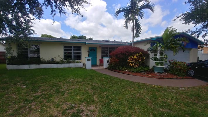 Exterior view of a senior living facility surrounded by greenery
