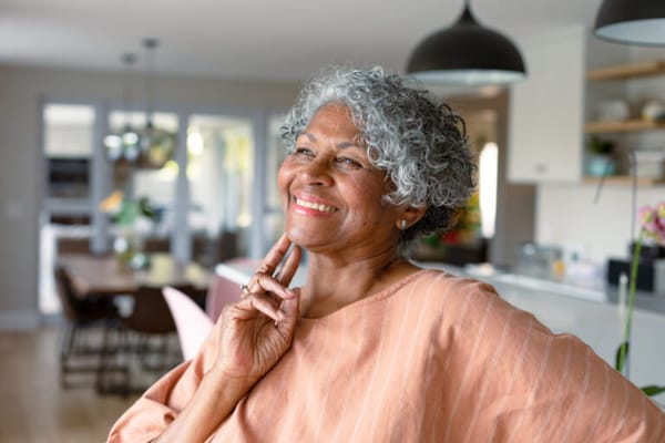 A resident smiling in a modern indoor setting