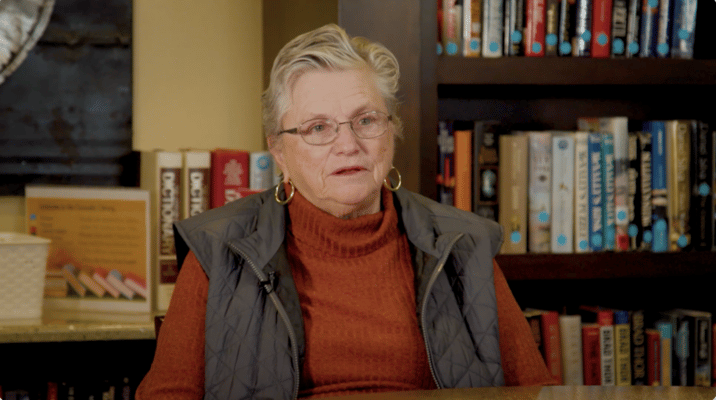Resident sitting in a cozy library area