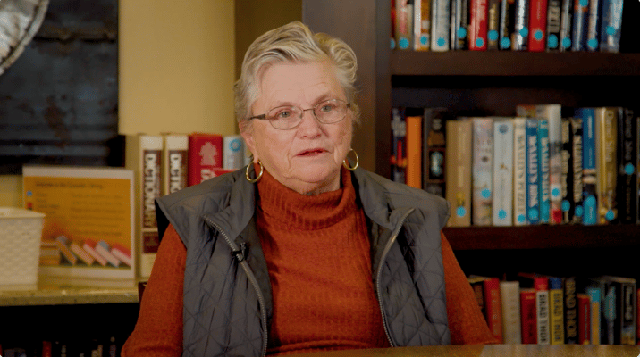 Resident sitting in a cozy library area