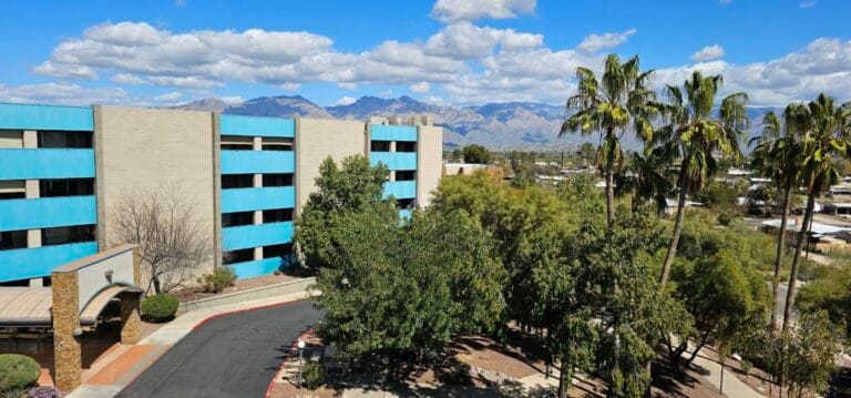 Exterior view of a senior living facility with mountains