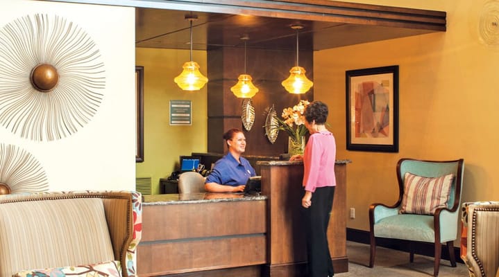 Reception area with staff assisting a resident