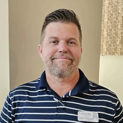 Staff member smiling with name badge