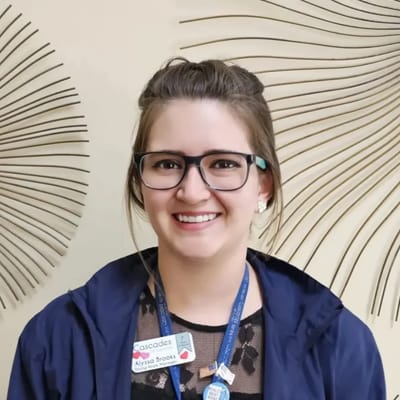Staff member smiling in a well-lit lobby area