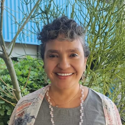 Smiling woman outdoors in a garden setting